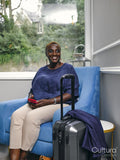 Smiling woman sitting in armchair in hotel lobby