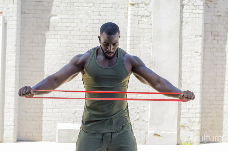 Mid adult man exercising with resistance band