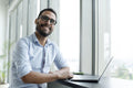 Businessman with laptop working in modern office