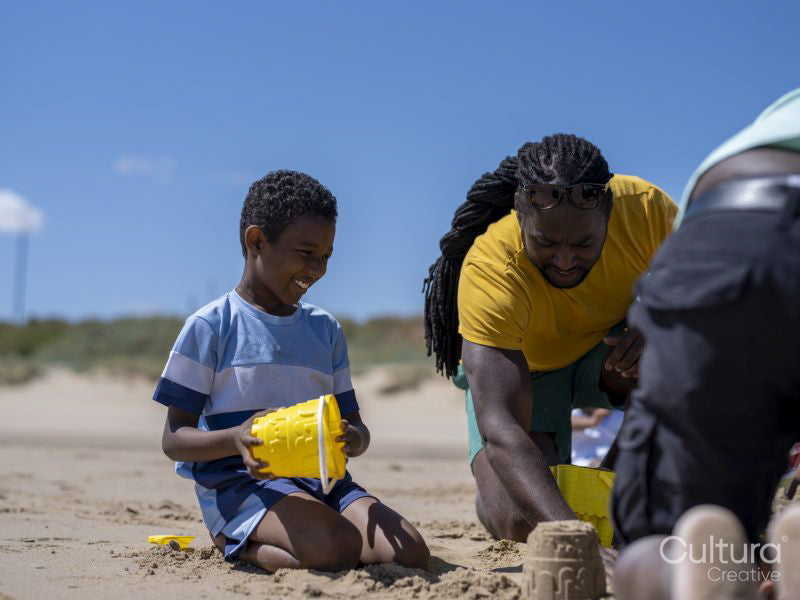 Father and son building sand castles on beach