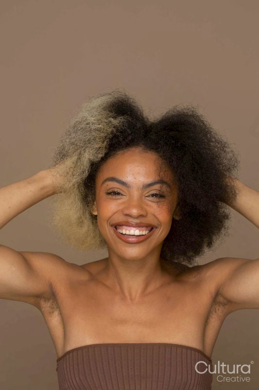 Studio portrait of smiling woman with two toned hair