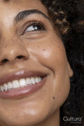 Smiling woman with brown eyes and freckles