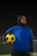 Portrait of female soccer player holding ball