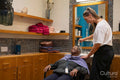 Smiling senior woman getting hair washed in hair salon