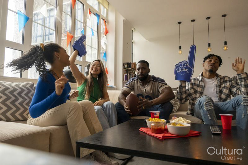 Friends watching sport game on TV at home