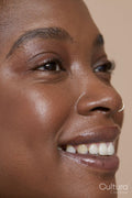 Close-up of smiling woman with nose ring