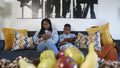 Siblings using tablet and smart phone at home