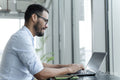 Businessman with laptop working in modern office