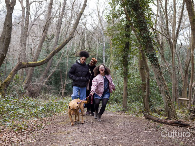 Mother with two daughters and dog in forest