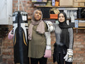 Two women standing in exercising facility during boxing training