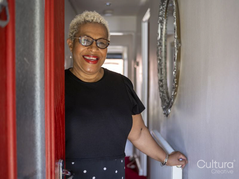 Portrait of mature woman standing in doorway