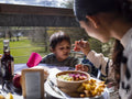 Mother feeding son at restaurant table