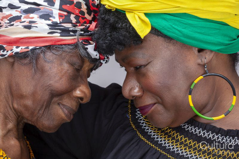 Senior woman and mature daughter wearing headscarfs