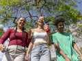 Smiling friends walking on sunny day