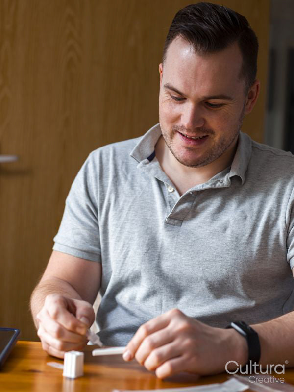 Man sitting at table with coronavirus cassette rapid test