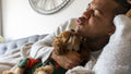 Man and dog relaxing on sofa