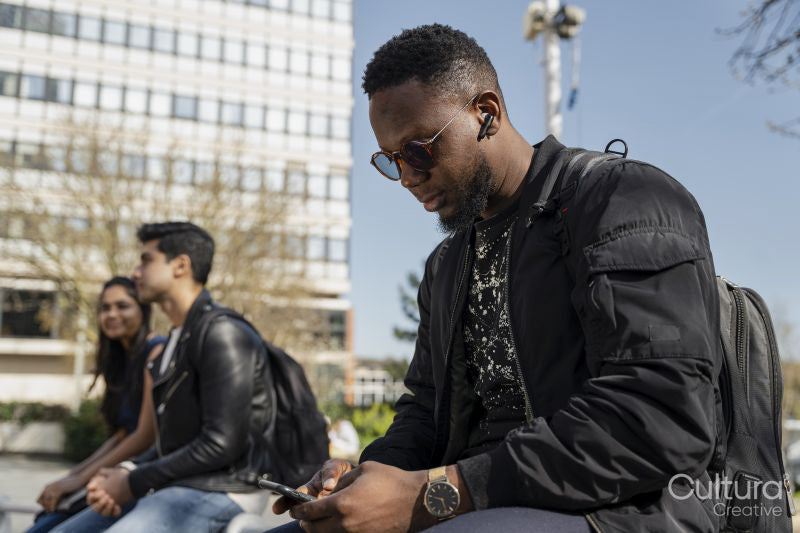 Male student using phone on campus