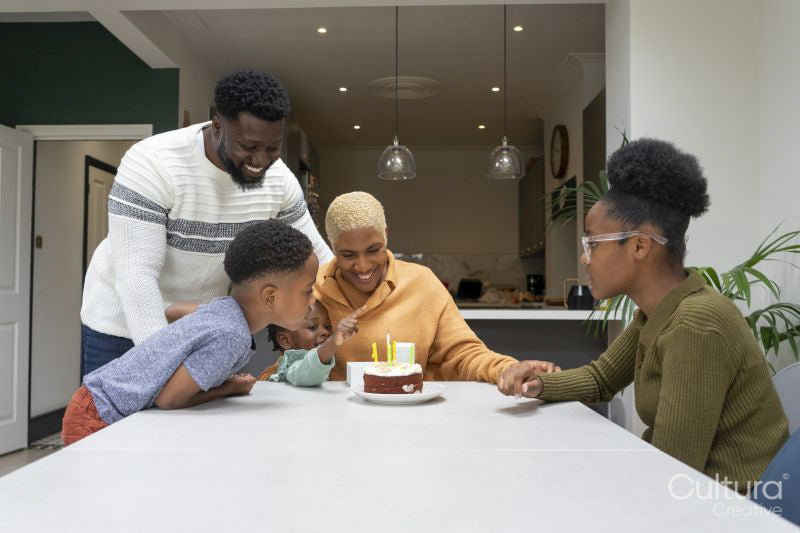 Family with children celebrating birthday at home