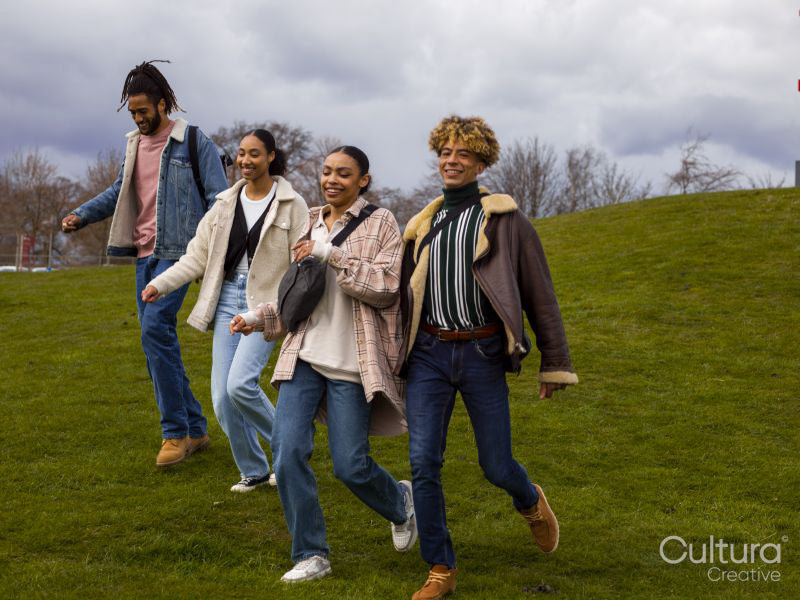 Group of young friends walking across lawn
