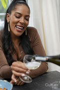 Woman pouring wine during party