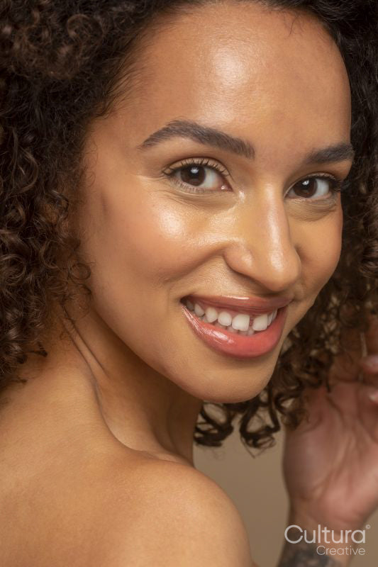 Close-up of smiling woman with curly hair