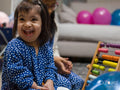 Sisters using colorful abacus at home