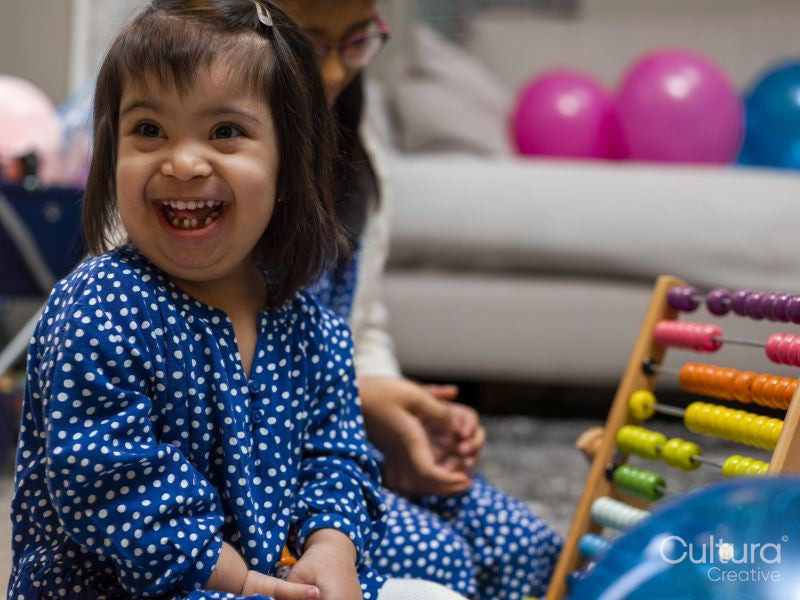 Sisters using colorful abacus at home