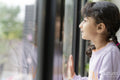 Little girl looking out window