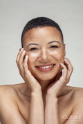 Studio portrait of smiling shirtless woman