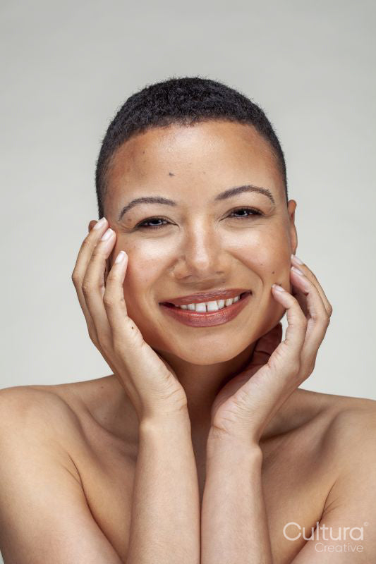 Studio portrait of smiling shirtless woman