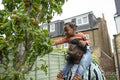 Father giving daughter piggyback ride
