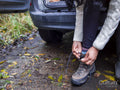 Woman putting on hiking shoes