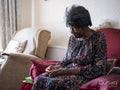 Elderly woman sitting in armchair