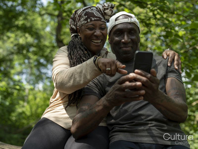 Smiling mature couple taking selfie on hike