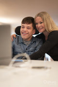 Mother and disabled son using laptop