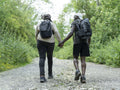 Mature couple holding hands while hiking