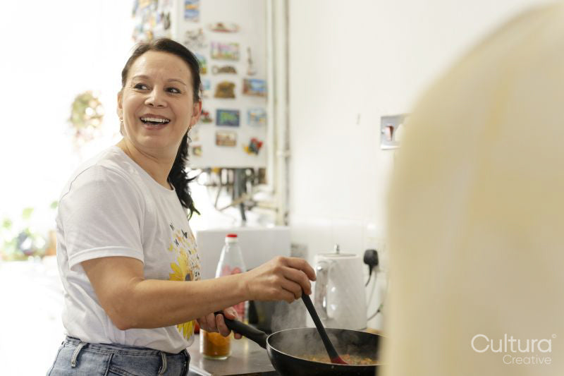 Mature woman preparing food in kitchen