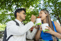 Tourist couple eating street food