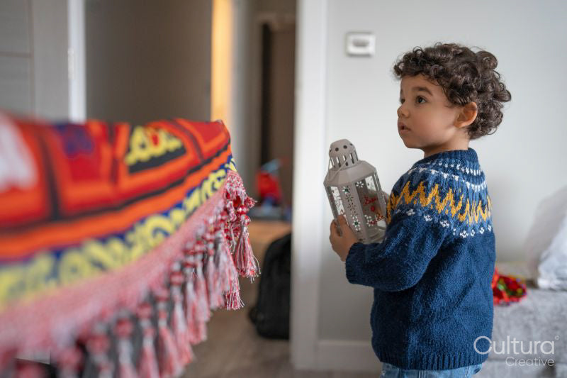 Boy playing with lantern at home