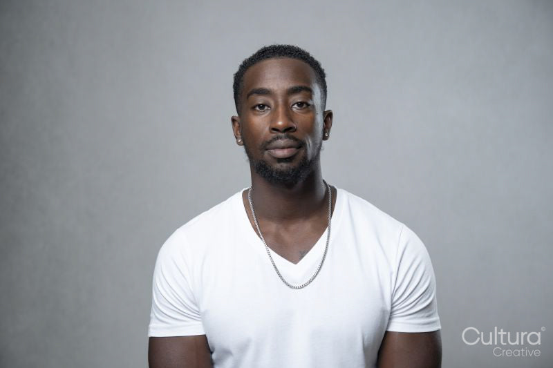 Portrait of man wearing white t-shirt and necklace