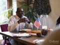 Smiling man sitting at Thanksgiving table