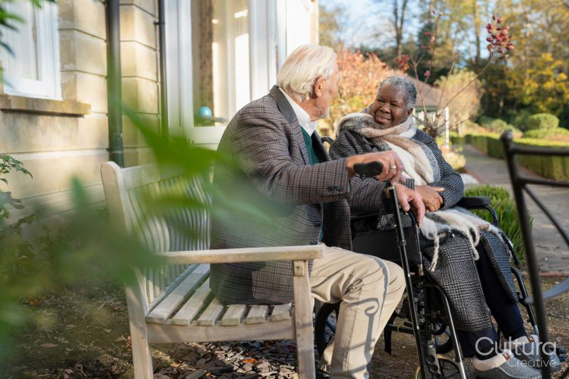 Smiling senior people relaxing on bench in park
