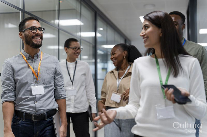Group of office workers walking together in office corridor