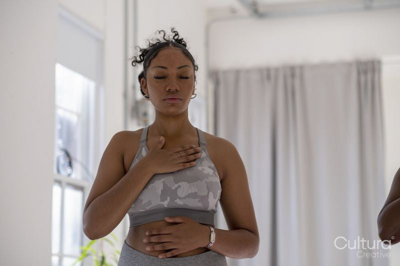 Teenage girl practicing pranayama in yoga studio