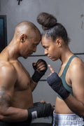 Woman and man face to face in boxing ring