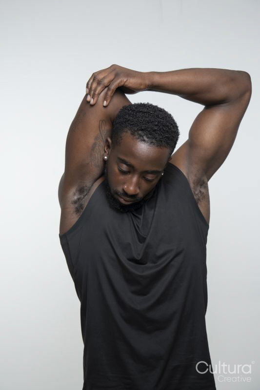 Muscular man stretching arms