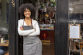 Portrait of smiling cafe owner at doorway