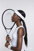Profile of athletic woman with tennis racket