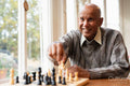 Senior man playing chess in nursing home