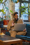 Man sitting on sofa and using laptop